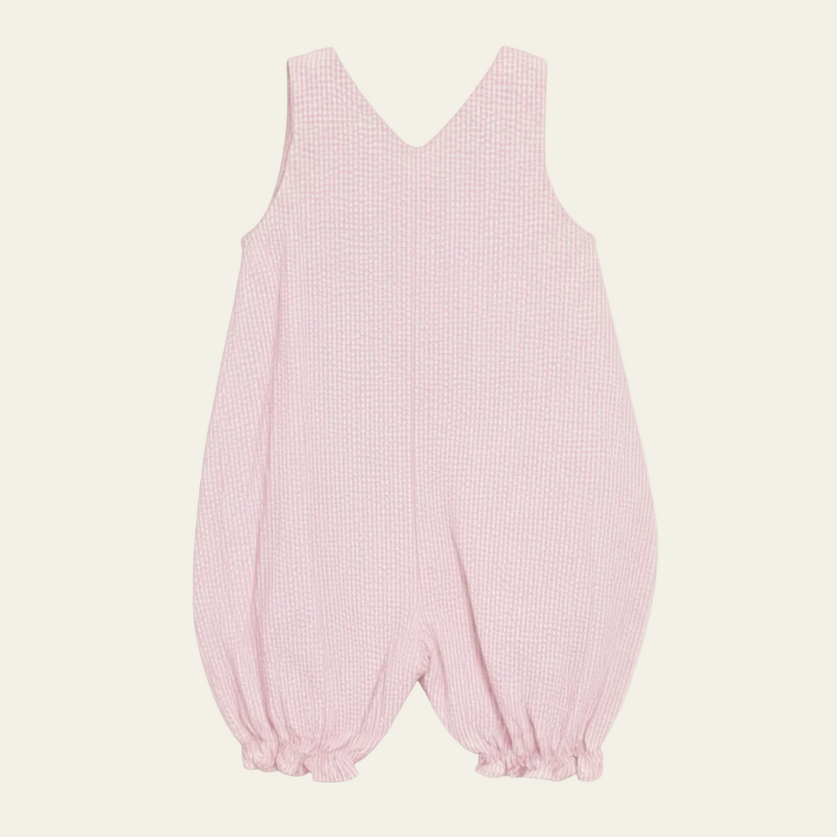 Petit Ami pink seersucker romper, back, showing the crossed straps and gathered leg cuffs