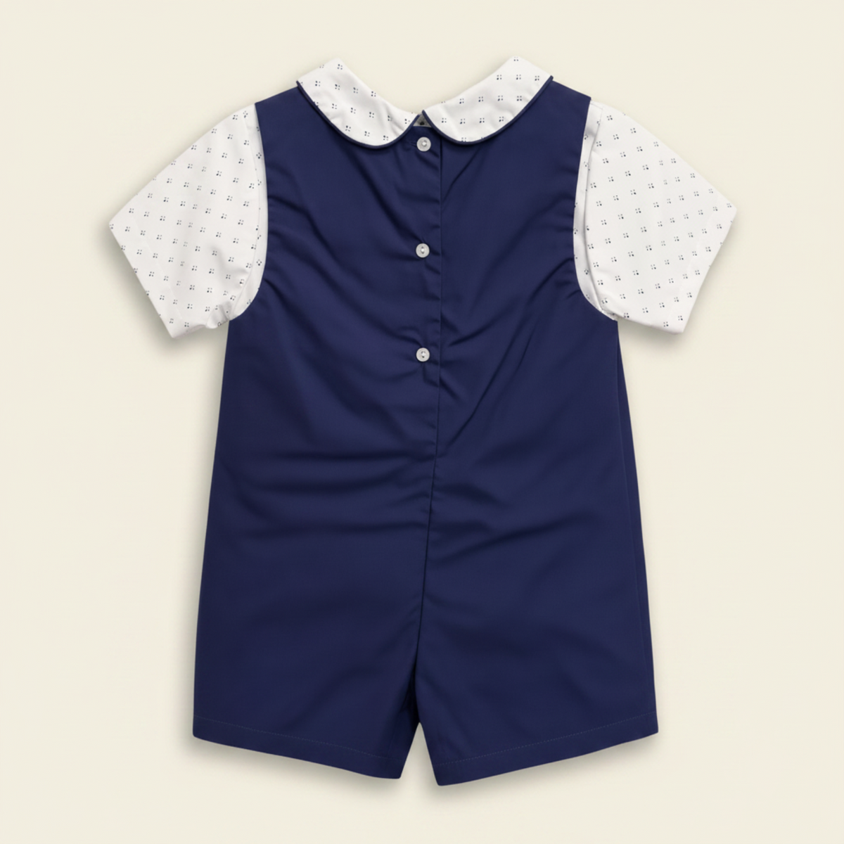 Petit Ami navy whale bobby suit, back, showing the buttoned closure
