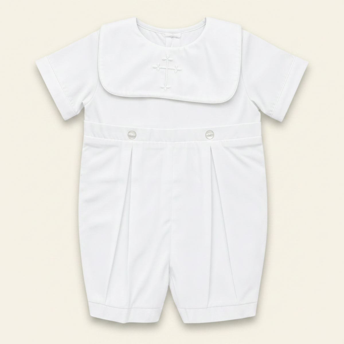 Petit Ami white christening bobby suit with a hand-embroidered cross on the bib front