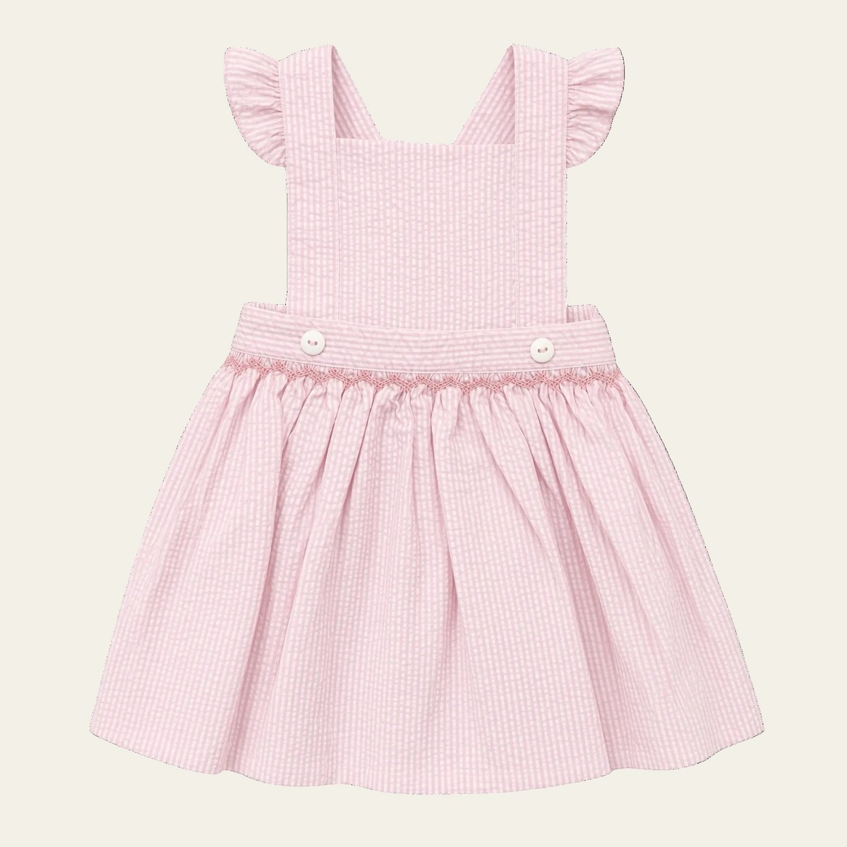 Petit Ami pink seersucker pinafore with hand-smocked waist and flutter sleeves, front