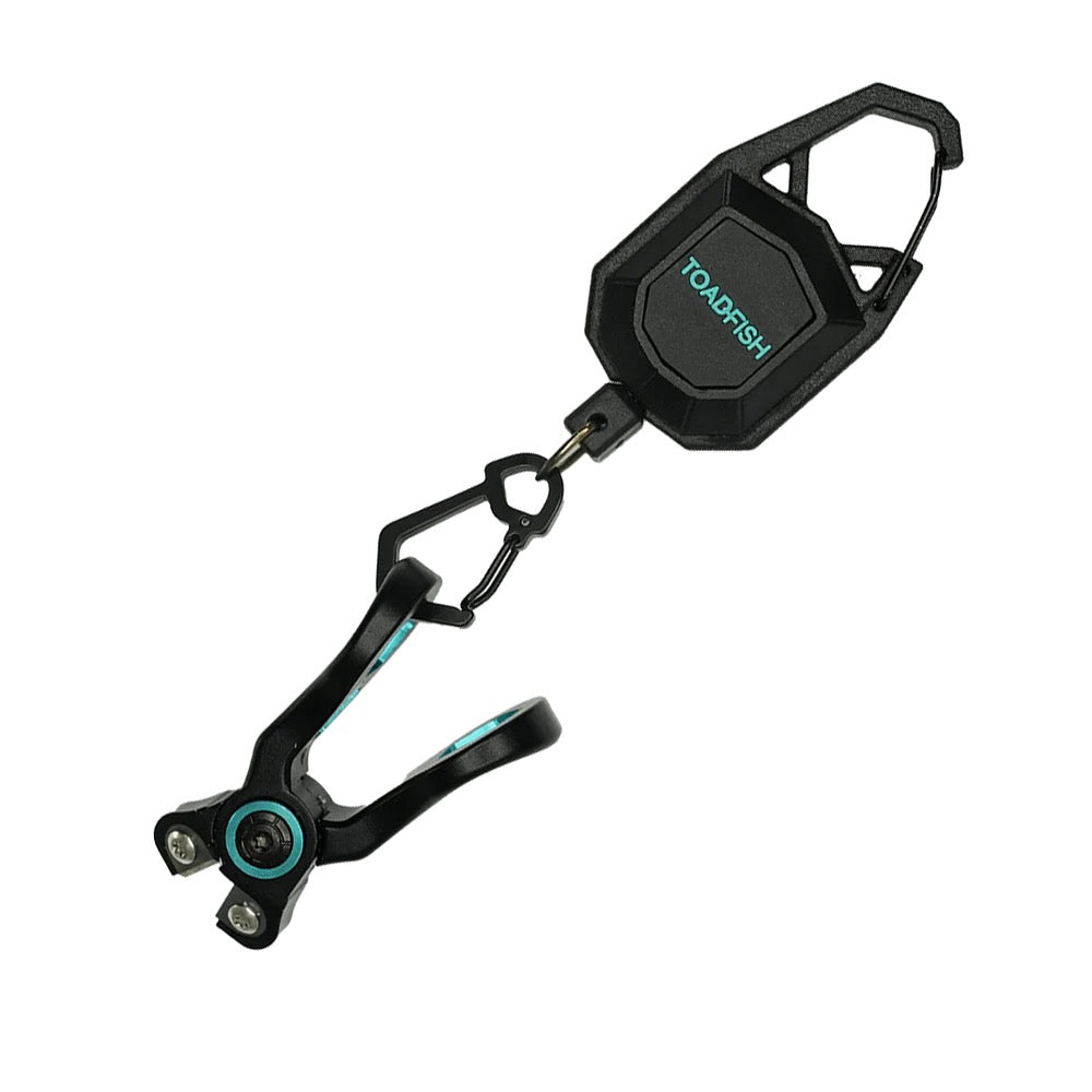 Toadfish stainless line nippers attached to a black retractable clip with carabiner, teal accents on the jaws and pivot