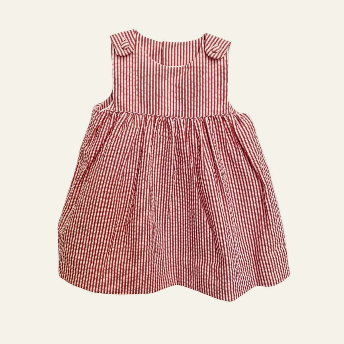Petit Ami red and white stripe seersucker sundress, front, with buttoned shoulder tabs and a full gathered skirt