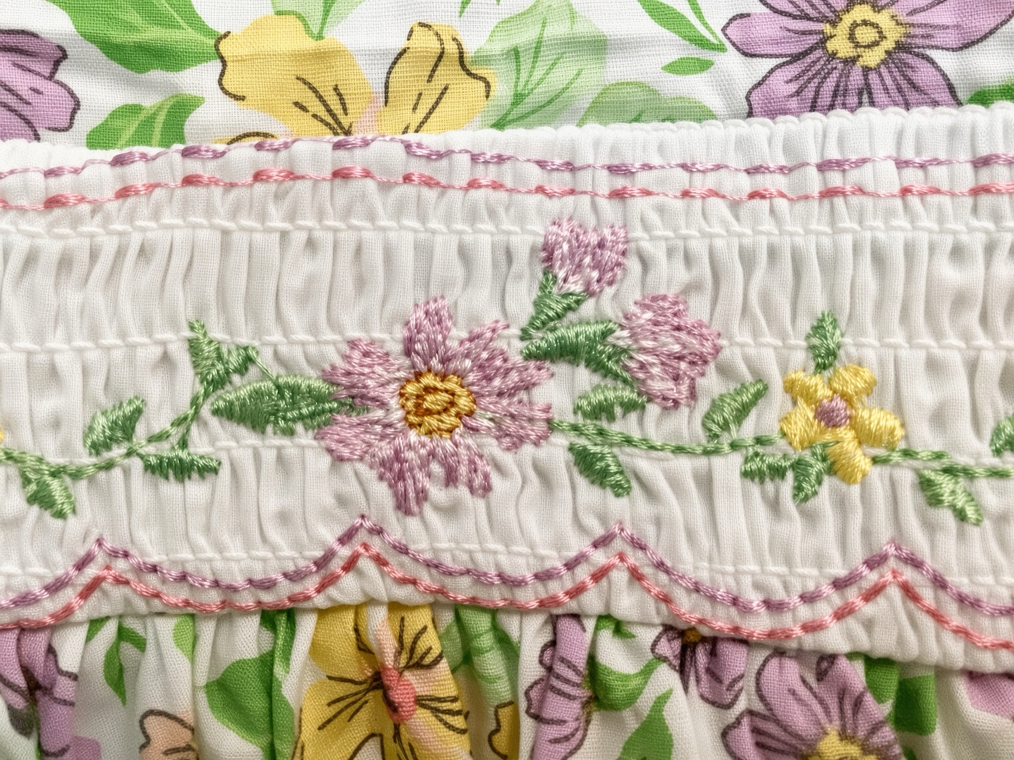 Detail of the hand-smocked and embroidered waist band on the floral sundress